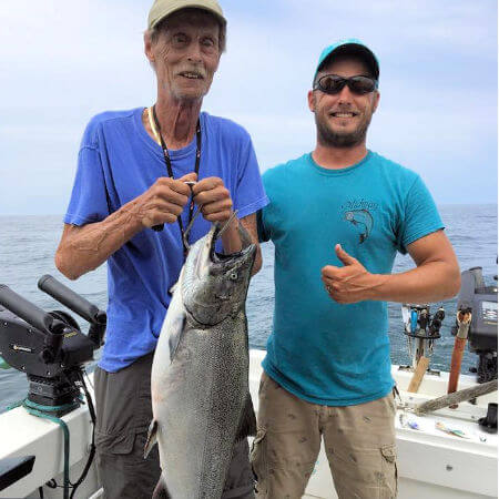 elderly gentleman from henderson harbor ny had his hands full catching this heavy king salmon