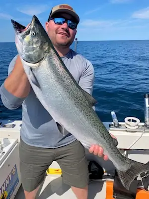 Angler with a large chinook salmon caught in June.