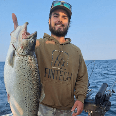 Man holding giant Lake Ontario Brown Trout.
